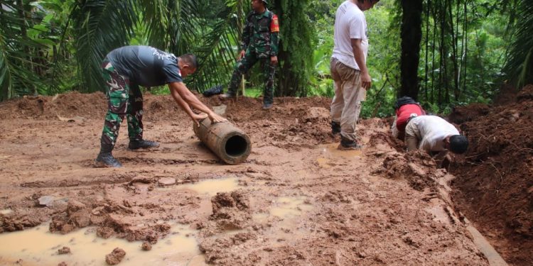 Meski diguyur Hujan, Satgas TMMD ke 123 dan Warga Tetap Semangat Pasang Buis Beton